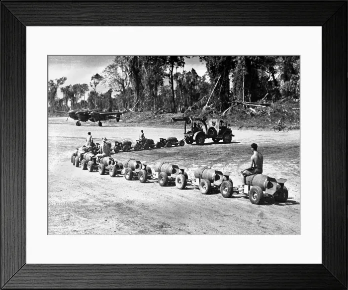 Framed Print : Three U.S. Marines ride on a truck drawn bomb train at a Pacific air base. 1944. World War 2. (BSLOC_2014_10_161)