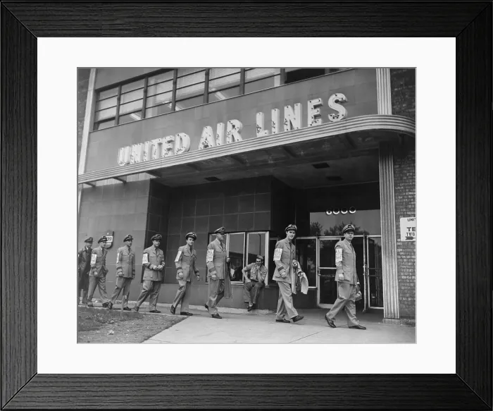 Framed Print : United Air Lines uniformed pilots form a picket line as they march past the airline's Chicago Midway terminal. 1951 Framed Print : United Air Lines uniformed pilots form a picket line as they march past the airline's Chicago Midway terminal. 1951