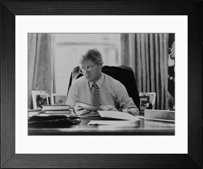Framed Print : Informal portrait of President Bill Clinton at his desk in the Oval Office. 1993. (BSLOC_2015_2_187) Framed Print : Informal portrait of President Bill Clinton at his desk in the Oval Office. 1993. (BSLOC_2015_2_187)