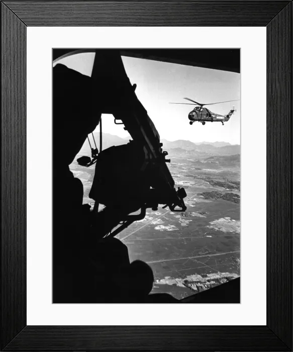 Framed Print : Vietnam War. US Army Helicopter in flight viewed from behind the door gunner of a companion helicopter. Ca. 1965 Framed Print : Vietnam War. US Army Helicopter in flight viewed from behind the door gunner of a companion helicopter. Ca. 1965