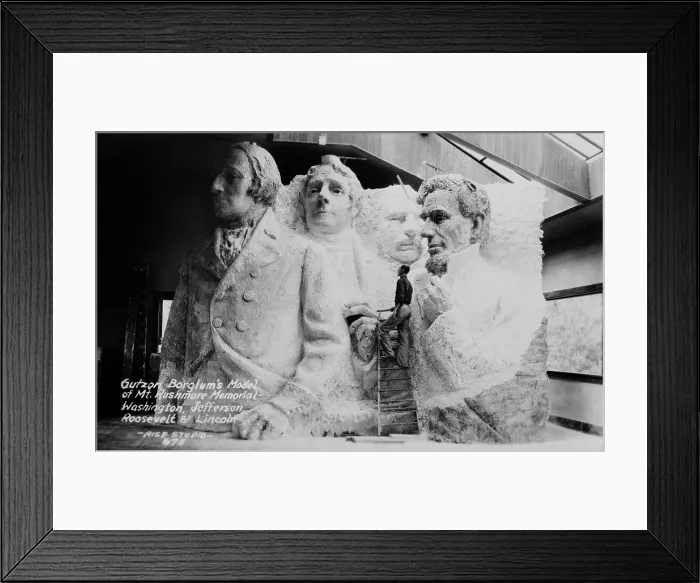Framed Print : Sculptor Gutzon Borglum (1871-1941), on a ladder with his model of Mt. Rushmore memorial. 1936. (BSLOC_2013_8_247)