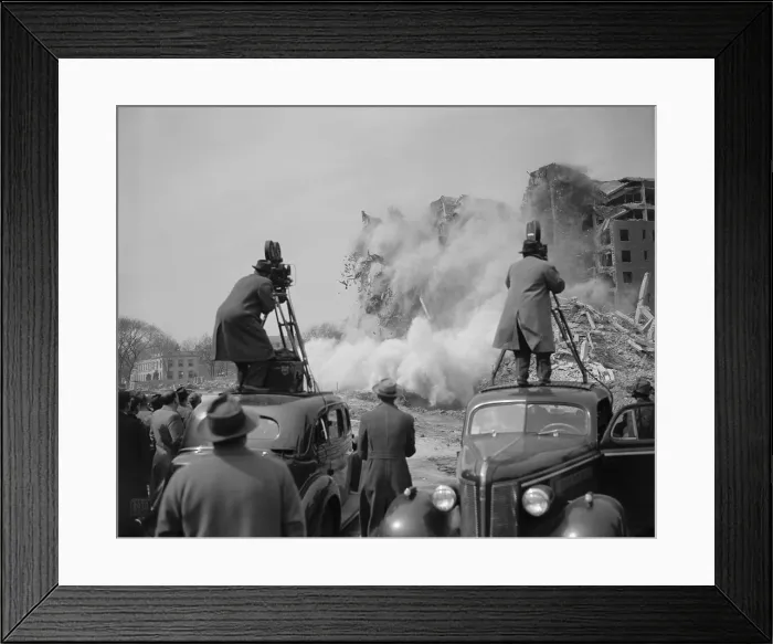 Framed Print : News photographers filming a building demolition in Washington, D.C. ca. 1940. They are standing on the top of automobiles to get a better angle of the explosion scene