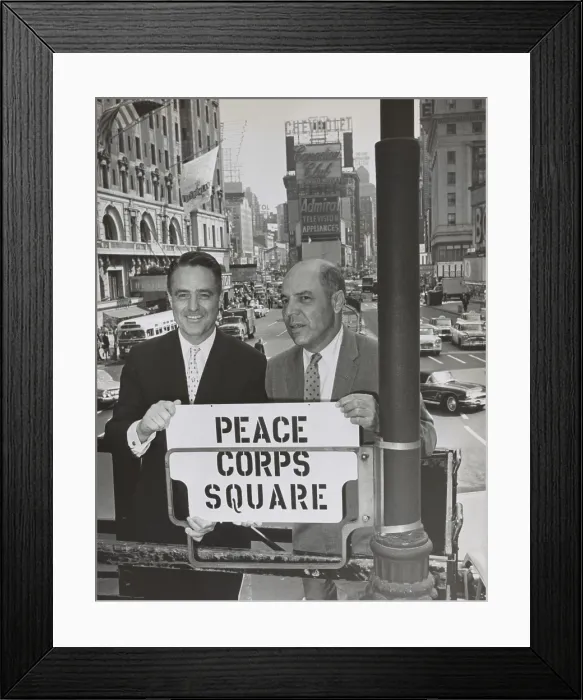Framed Print : Sargent Shriver and Edward R. Dudley in Times Square with a sign Peace Corps Square
