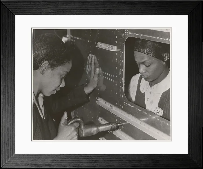 Framed Print : African American women riveters work on the center section of a bomber during World War 2. Ca. 1940-45. (BSLOC_2014_10_215) Framed Print : African American women riveters work on the center section of a bomber during World War 2. Ca. 1940-45. (BSLOC_2014_10_215)