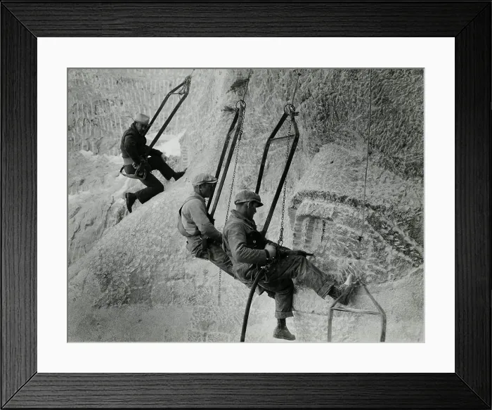 Framed Print : Mount Rushmore workers hanging in swing seats, Ca. 1935. They use jackhammers to carve Jefferson's eye as sculptor Gutzon Borglum observes Framed Print : Mount Rushmore workers hanging in swing seats, Ca. 1935. They use jackhammers to carve Jefferson's eye as sculptor Gutzon Borglum observes