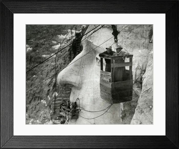 Framed Print : Gutzon Borglum and his son, Lincoln, in the Mt. Rushmore tramway, Nov. 23, 1935. The Jefferson sculpture is tasking it's finished form behind them