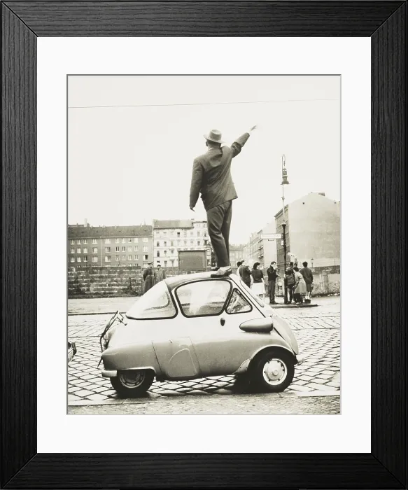 Framed Print : A man standing on top of a small three-wheeled car waving across the newly constructed Berlin Wall. This West Berliner waves to East Berliners on Sept Framed Print : A man standing on top of a small three-wheeled car waving across the newly constructed Berlin Wall. This West Berliner waves to East Berliners on Sept