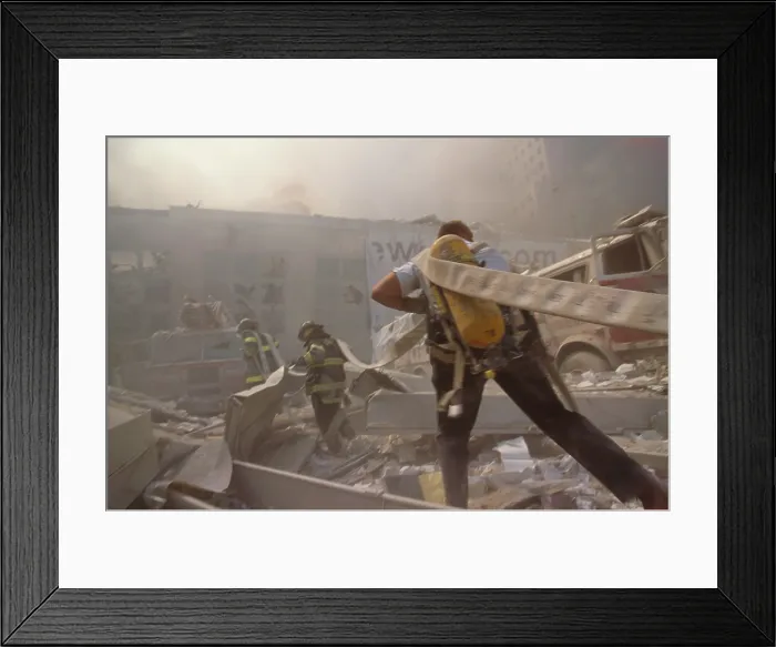 Framed Print : Fire fighters hauling a hose through rubble on September 11th, following terrorist attack on World Trade Center