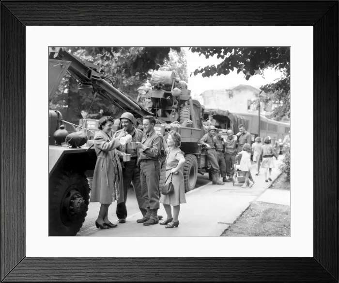 Framed Print : English townsfolk serve hot coffee to U.S. Army Ordnance men. They are awaiting their go signal to join the ongoing invasion of France. July 24, 1944. World War 2