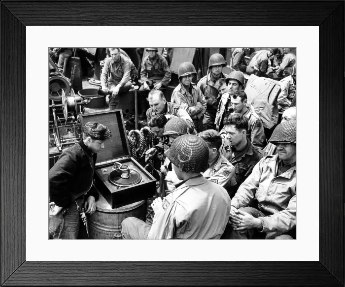 Framed Print : U.S Infantrymen listen to a phonograph on their way to Utah Beach. The numbers on their helmets indicates their unit number within the 90th U.S. Infantry Div. Ca. June 10, 1944