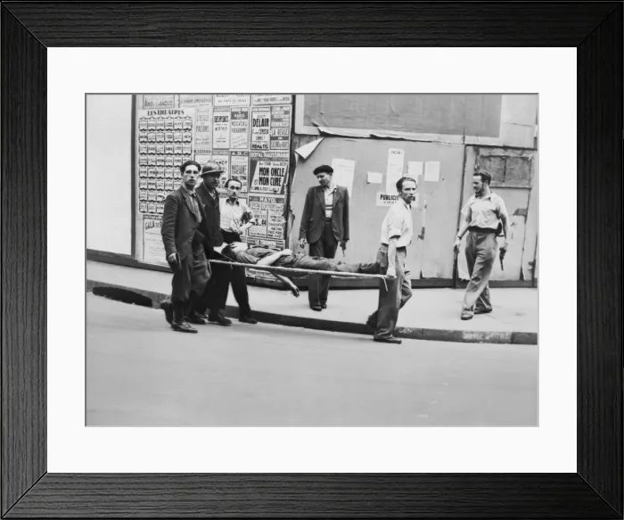 Framed Print : F.F.I. (French Forces of the Interior) partisan carried on stretcher, possibly in Paris. Other men carrying pistols walk alongside. Ca. July-Aug. 1944. World War 2