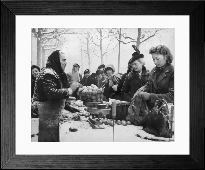 Framed Print : Parisians purchasing apples from a street vendor in the snow 1945. The first winter after liberation was difficult for civilians due to shortages of food and fuel Framed Print : Parisians purchasing apples from a street vendor in the snow 1945. The first winter after liberation was difficult for civilians due to shortages of food and fuel