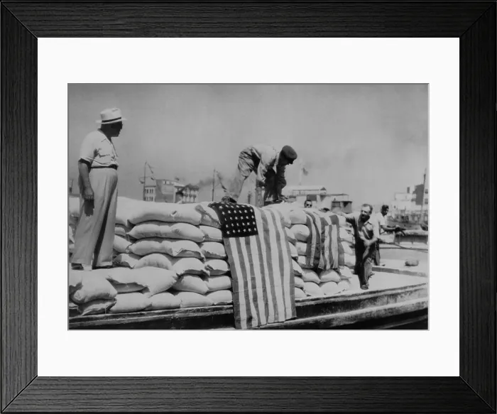 Framed Print : Sacks of flour, the first relief supplies from the United States, being unloaded in the port of Piraeus. American and Greek flags are displayed. 1947. The U.S