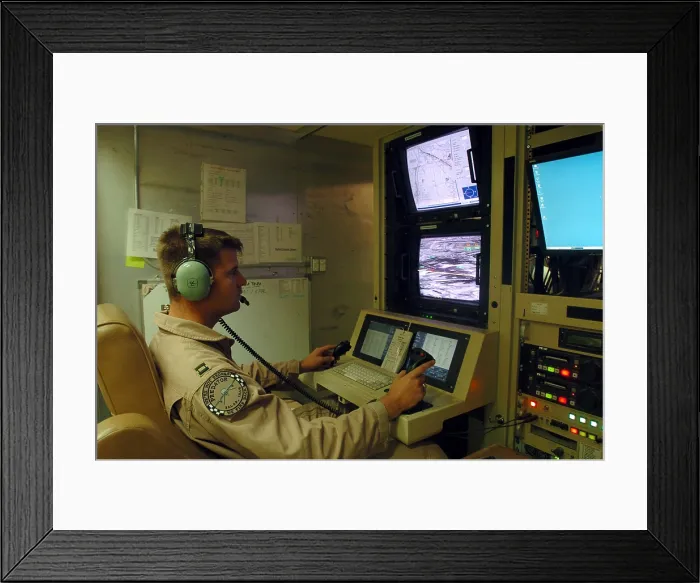 Framed Print : An Air Force officer maneuvers an unmanned Predator reconnaissance airplane over Iraq by remote control at Balad Air Base Iraq. July 2 2004. (BSLOC_2011_12_299)