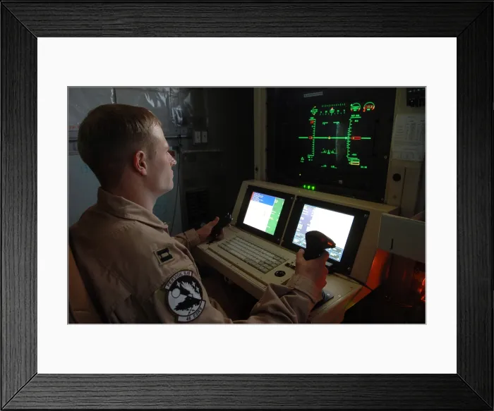 Framed Print : An Air Force officer maneuvers an unmanned Predator reconnaissance airplane over Iraq by remote control at Balad Air Base. Predators can be equipped with Hellfire missiles. Iraq