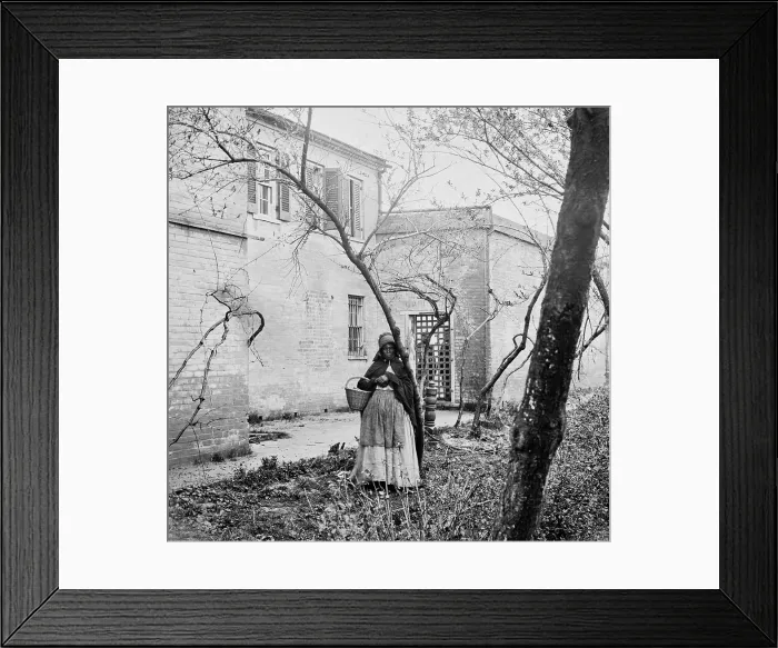 Framed Print : Exterior of the slave pen of Price, Birch & Co. dealers in slaves, of Alexandria, Virginia with an African American women standing in foreground