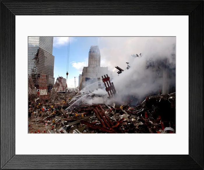 Framed Print : Firefighters douse the still burning pile of ruins of the World Trade Center two days after the 9 / 11 terrorists attacks. Sept