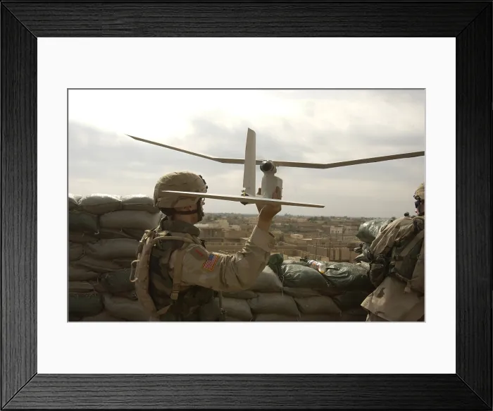 Framed Print : US soldier launches a Raven unmanned aerial vehicle to conduct reconnaissance of insurgents attacking Patrol Base Uvanni in Samarra Iraq. Nov. 6 2004. (BSLOC_2011_12_303)