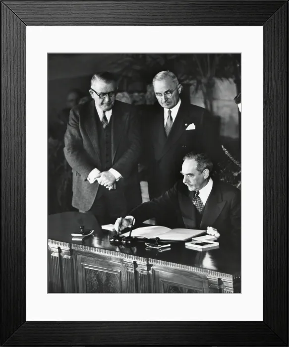 Framed Print : Dean Acheson, Sec. of State, signs the North Atlantic Treaty establishing the NATO alliance. President Harry Truman and Vice President Alben Barkley witness. April 4, 1949 Framed Print : Dean Acheson, Sec. of State, signs the North Atlantic Treaty establishing the NATO alliance. President Harry Truman and Vice President Alben Barkley witness. April 4, 1949