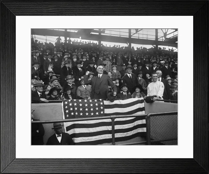 Framed Print : President Warren Harding throwing out the first ball at Washington game. Seated at left is First Lady Florence Harding