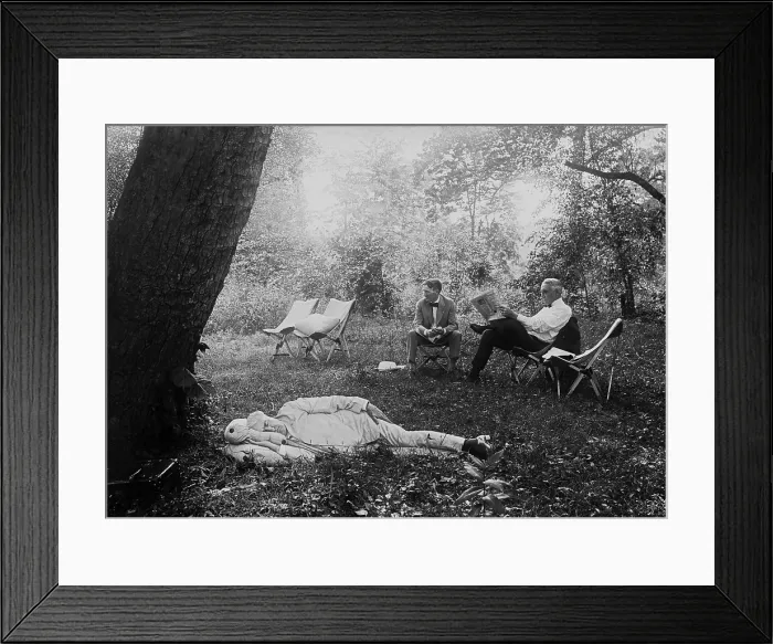 Framed Print : Thomas Edison naps under a tree, on July 19, 1921. In the background President Warren Harding reads a newspaper in a camp chair next to Harvey Firestone. Maryland Framed Print : Thomas Edison naps under a tree, on July 19, 1921. In the background President Warren Harding reads a newspaper in a camp chair next to Harvey Firestone. Maryland
