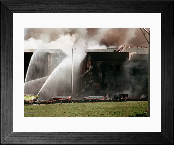 Framed Print : Firefighters struggle to contain the fire after the September 11 2001 terrorist attack on the Pentagon