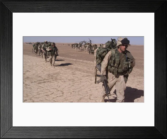 Framed Print : An Special Operations infantry company move across the desert in a file after the seizure of a forward operating baseduring the U.S