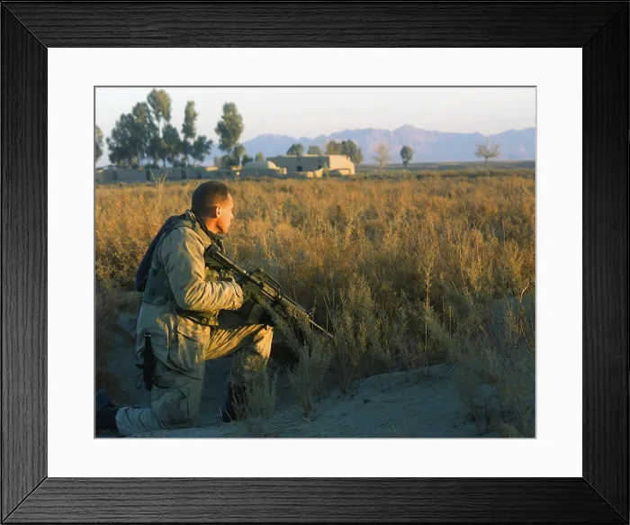 Framed Print : Marine Scout armed with M4 Carbine rifle provides security at a roadside south of Kandahar City during a patrol Framed Print : Marine Scout armed with M4 Carbine rifle provides security at a roadside south of Kandahar City during a patrol