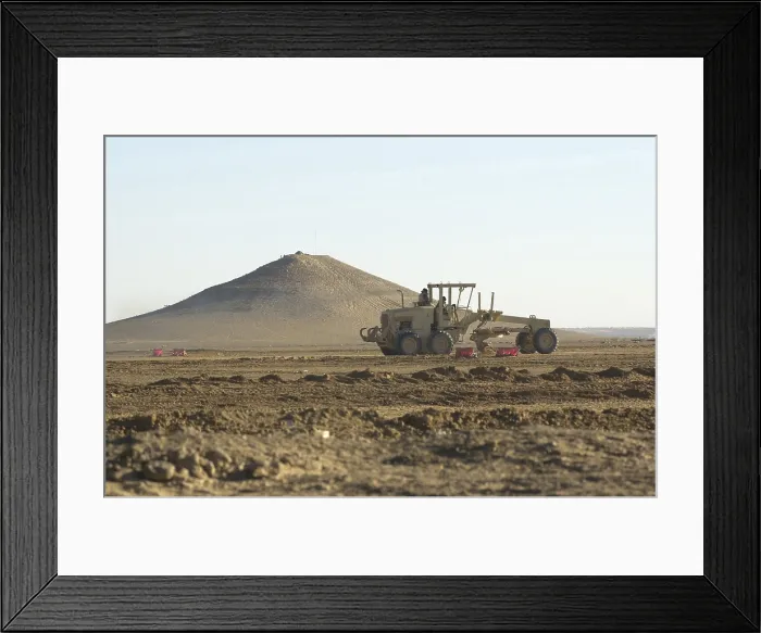 Framed Print : U.S. Navy Seabees run heavy graders down the runway to patch holes and remove excess dirt in the first weeks occupation of Kandahar on Dec. 18 2001