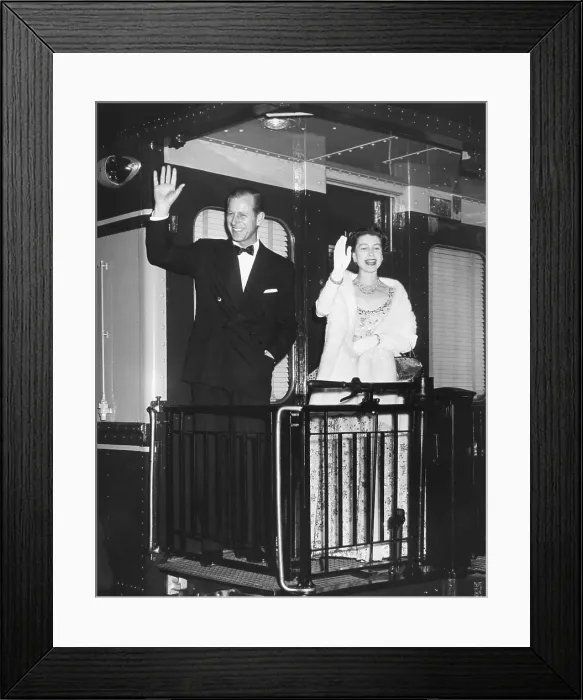 Framed Print : Queen Elizabeth II and Prince Philip wave from the back of a train at Union Station. After entertaining the President Eisenhower and the First Lady, they leave for New York City