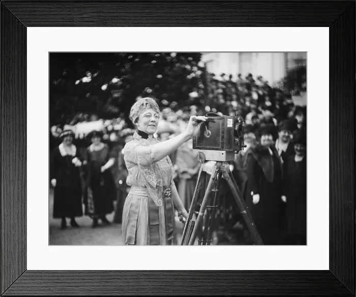 Framed Print : First Lady Florence Harding cranks a newsreel camera before a group of women journalists. Ca. 1921-23. (BSLOC_2015_15_68)