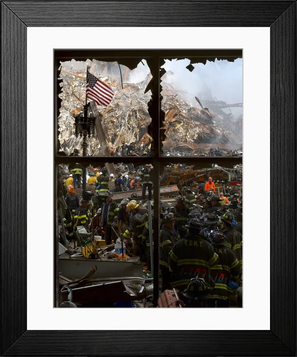 Framed Print : Seen through a broken window New York City firemen and rescue workers work their way toward the pile of burning ruins of the World Trade Center in New York City on Sept