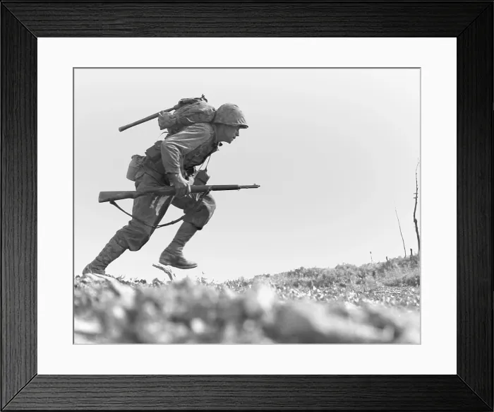 Framed Print : Marine Pfc. Paul E. Ison runs through Japanese machine gun fire on Okinawa, May 10, 1945. Ison and the rest of his unit made the dash unwounded