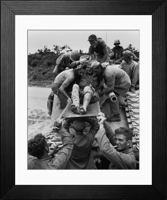 Framed Print : Wounded Marine is removed from a tank that carried him from the front lines on Okinawa