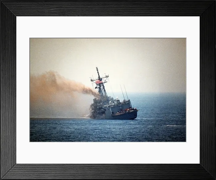 Framed Print : Guided missile frigate USS STARK listing to port after being struck by an Exocet missile launched from an Iraqi jet killing 37 sailors and injuring 21 were