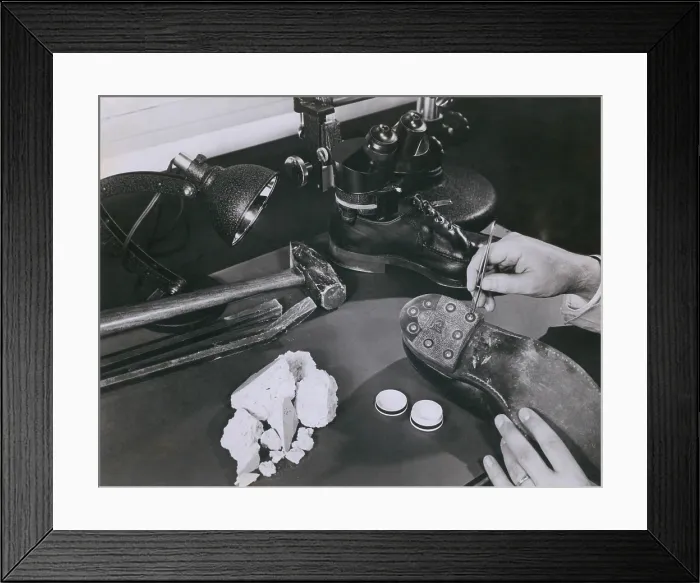 Framed Print : FBI forensic science. A technician removing safe insulation from the shoes of a burglary suspect at the FBI lab in 1954