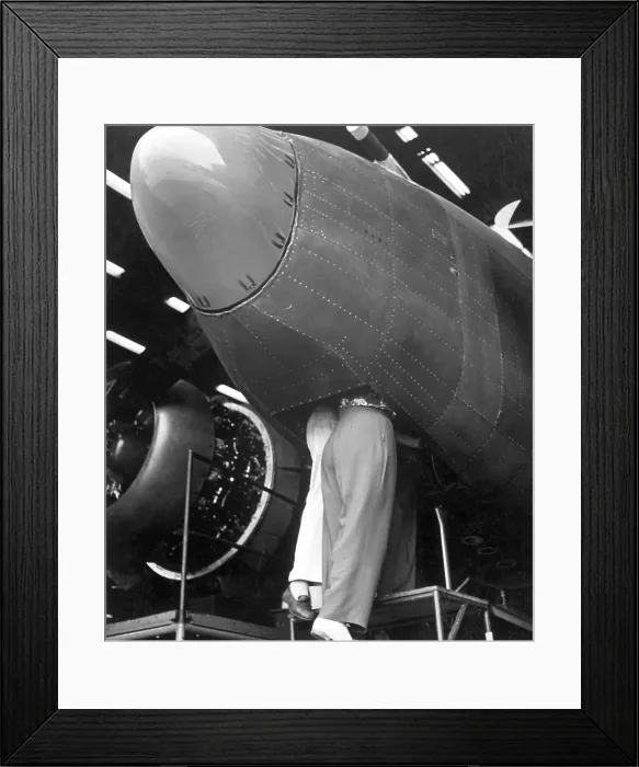 Framed Print : Two women workers standing through the bombardier's hatch at the Vega aircraft plant. Burbank, California, during World War 2, August 1943. (BSLOC_2013_14_121)