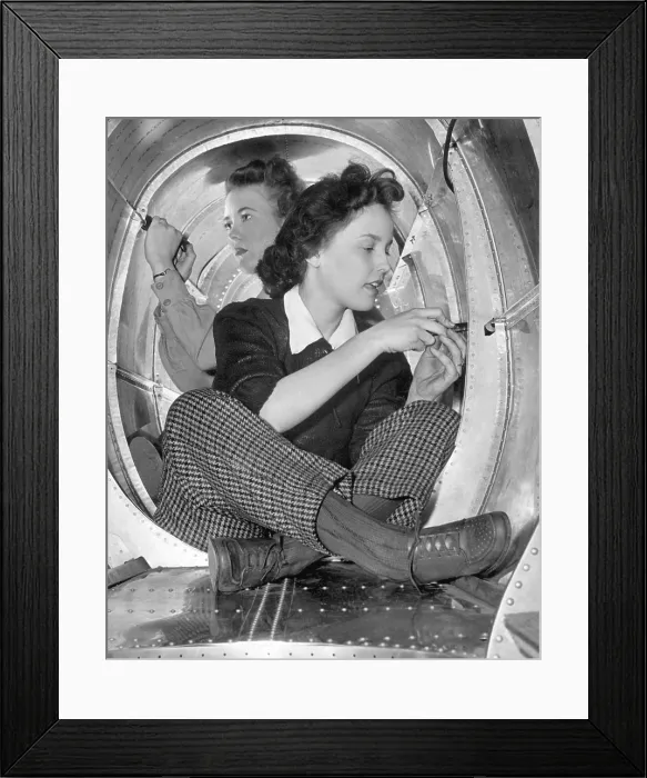 Framed Print : Two women workers in a cramped aircraft space at Grumman Aircraft Engineering Corp. During World War 2, ca. 1942-45. (BSLOC_2013_14_122) Framed Print : Two women workers in a cramped aircraft space at Grumman Aircraft Engineering Corp. During World War 2, ca. 1942-45. (BSLOC_2013_14_122)