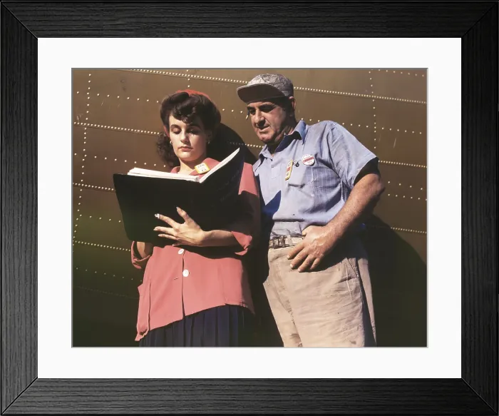 Framed Print : Female inspector confers with a co-worker when checking the center wings for C-47 transport planes. During World War 2, ca. 1942-45. (BSLOC_2013_14_123)