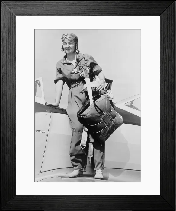 Framed Print : Nancy Harkness Love, wearing the uniform of the Women's Auxiliary Ferrying Squadron. She is standing on a airplane wing with her parachute harness slung over her shoulder