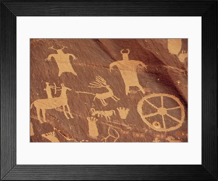Framed Print : Newspaper Rock Is a large cliff mural of ancient Indian petroglyphs and pictographs. This detail shows a rider on a horse and human figures
