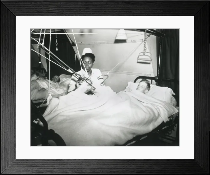 Framed Print : African America U.S. Army Nurse treats a German POW at a prisoner-of-war hospital in England. Oct. 7, 1944