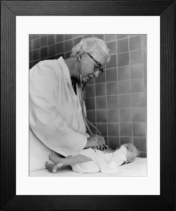 Framed Print : Dr. Virginia Apgar examining a newborn baby with stethoscope, Oct. 2, 1966. She introduced the Apgar Score, a way to quickly assess the health of newborns