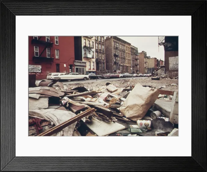 Framed Print : In a low income residential neighborhood in northeast Manhattan an empty lot is strewn with trash at 108th street and Lexington Avenue. Ca. 1973-75 Framed Print : In a low income residential neighborhood in northeast Manhattan an empty lot is strewn with trash at 108th street and Lexington Avenue. Ca. 1973-75