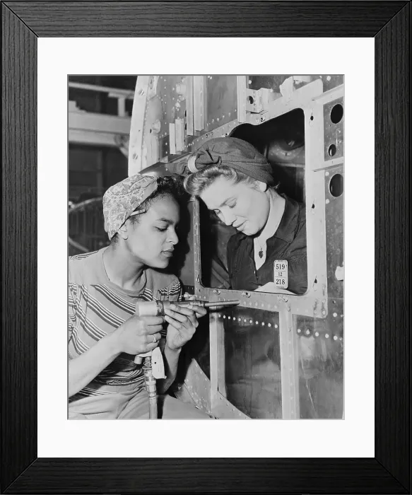 Framed Print : African American woman war worker with her white co-worker. Long Beach Plant of Douglas Aircraft Company had an racially integrated workforce during World War 2. Ca. 1942-45 Framed Print : African American woman war worker with her white co-worker. Long Beach Plant of Douglas Aircraft Company had an racially integrated workforce during World War 2. Ca. 1942-45