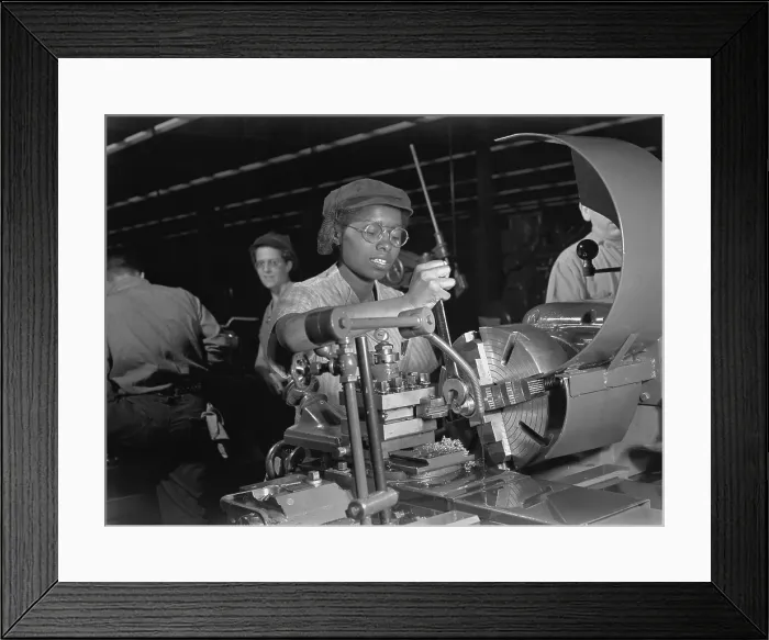 Framed Print : African American woman lathe operator at a Midwest supercharger plant. In the background are white workers in the racially integrated workforce during World War 2. Ca. 1942-45