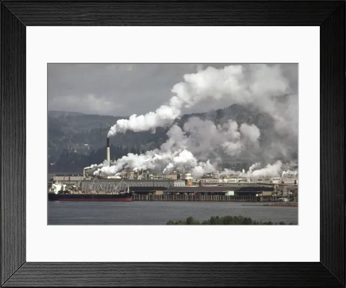 Framed Print : Air pollution is visible from the Weyerhaeuser paper mills and Reynolds metal plant both located in Longview Washington on the Columbia River. Ca. 1973-75