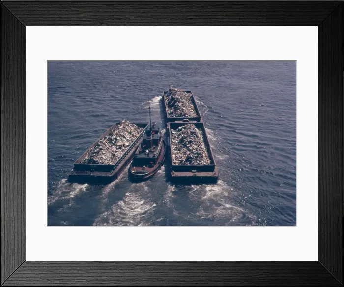 Framed Print : Tug boats tow barges of garbage down the East River to an overflowing Staten Island landfill. In the early 1970s New York City produced 26 000 tons of solid waste daily. Ca