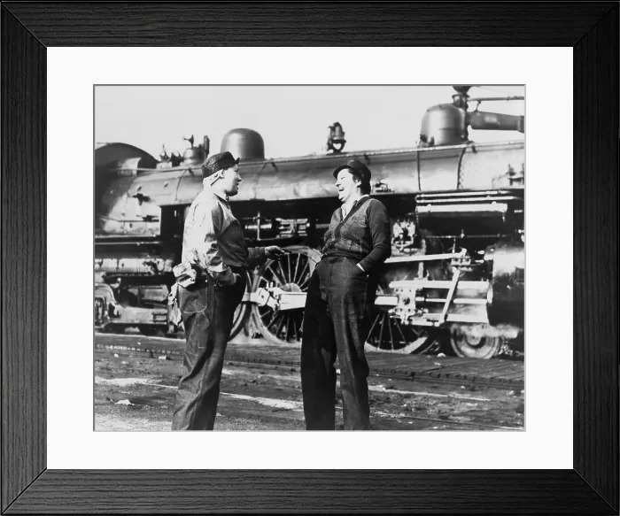Framed Print : Two American women railroad workers talk after they have cleaned and prepared a locomotive for operation. They are women war workers during World War 2. (BSLOC_2013_14_135)
