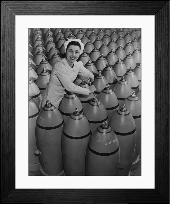 Framed Print : Canadian woman munitions worker tightening the nose plugs on 500-pound aerial bombs. 1942-43, during World War 2. (BSLOC_2013_14_147)